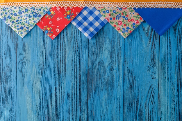 Few pieces of fabric on blue table background