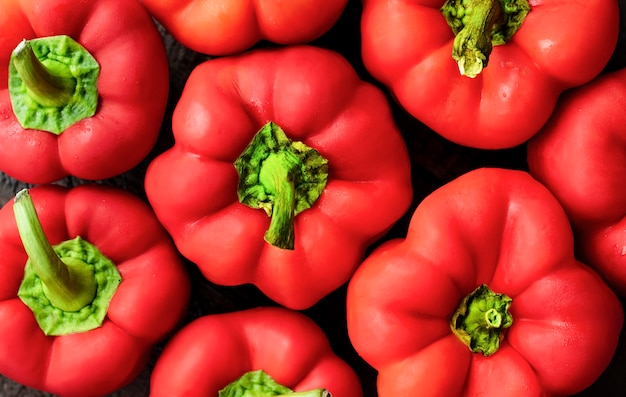 A few red bell peppers. background vegetables