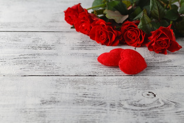 Few red roses on white table