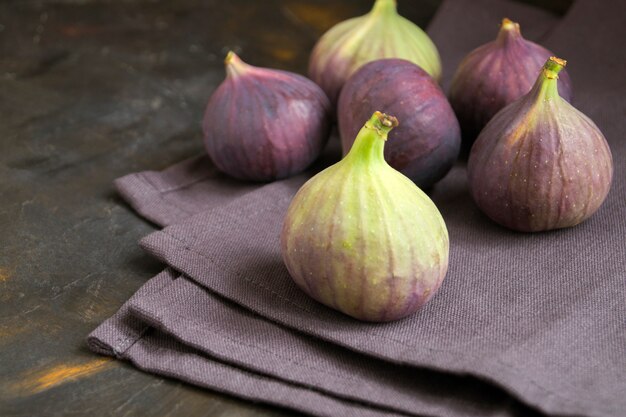 A few ripe figs on a dark 