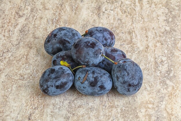 Few Ripe plum heap over background