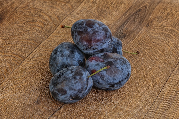 Few Ripe plum heap over background