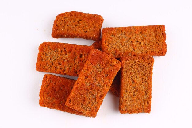 A few rye croutons on a white background