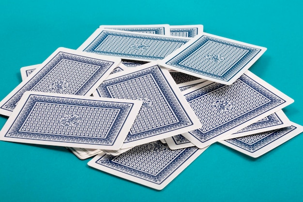 A few scattered playing cards on a green background