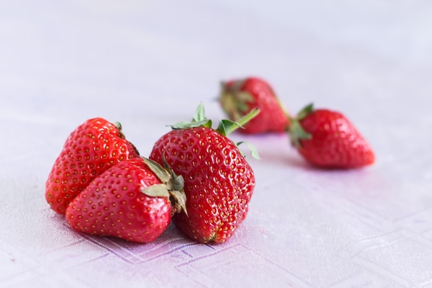 A few strawberries on a white tablecloth