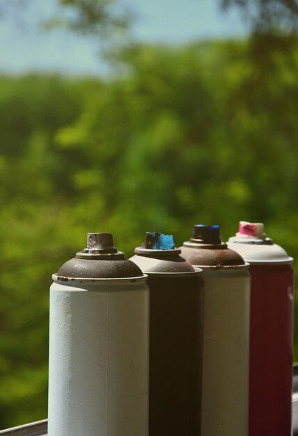 A few used aerosol paint sprayers lie on the windowsill in the workshop of a graffiti artist the