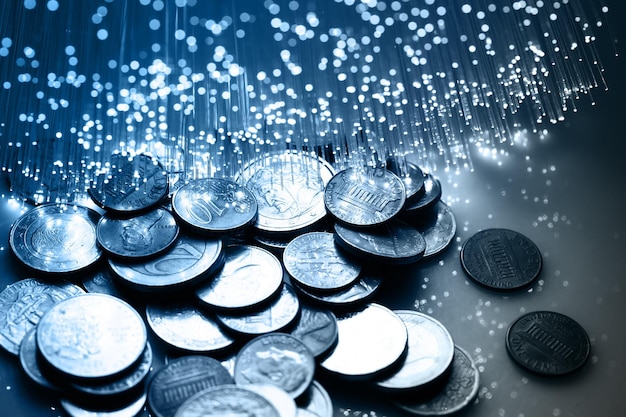 Photo fiber optics background a pile of coins with the word sparkle on the bottom
