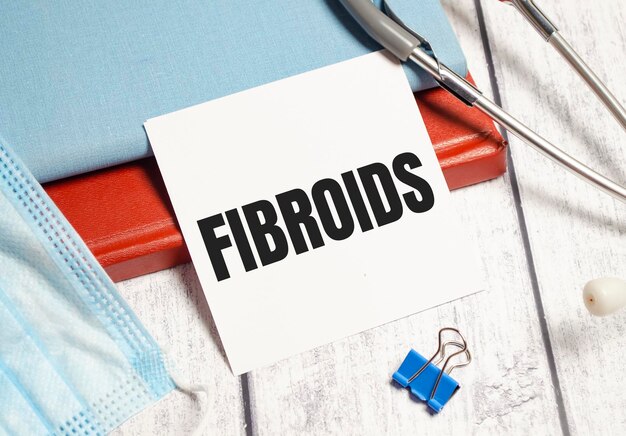 Fibroids word on white sticker and stethoscope on white background