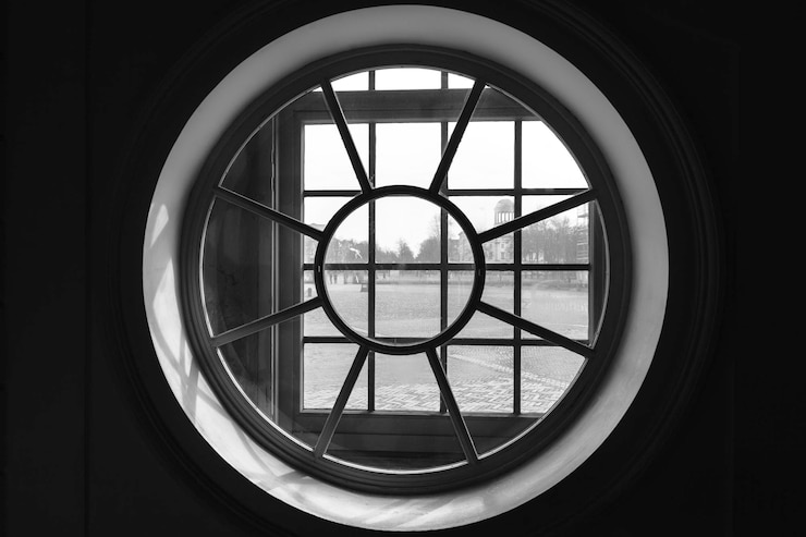 Photo field against sky seen from glass window