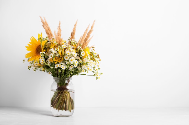 Field flowers in a glass vase. Summer bouquet of flowers