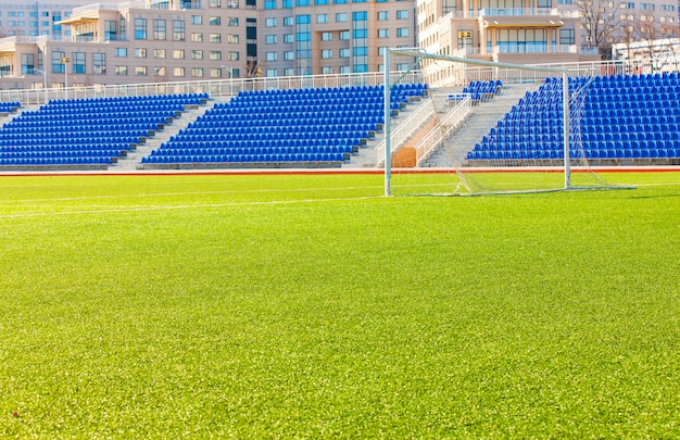 Field for game in soccer with a gate and bleachers.