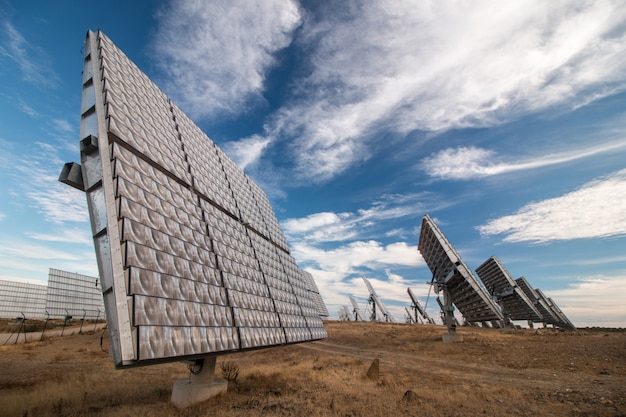 Field of photovoltaic solar panels gathering energy.