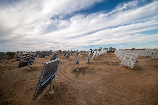 Field of photovoltaic solar panels gathering energy.