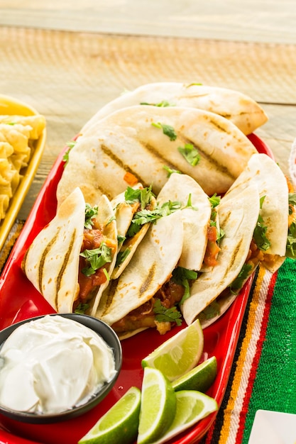 Fiesta party buffet table with chicken quesadilla and other traditional Mexican food.