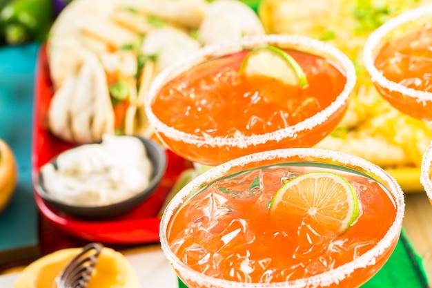 Fiesta party buffet table with watermelon margaritas and other traditional Mexican food.