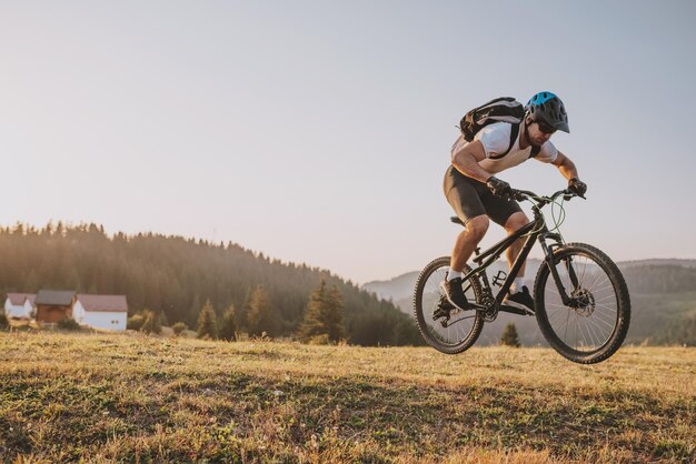 Fietser fietsen op de trail in het bos man fietsen op enduro trail track sport fitness motivatie en inspiratie extreme sport concept selectieve focus foto van hoge kwaliteit