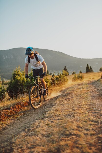 Fietser Fietsen op de Trail in het bos Man fietsen op enduro trail track Sport fitness motivatie en inspiratie Extreme Sport Concept Selectieve focus Foto van hoge kwaliteit