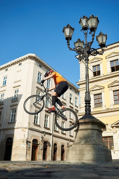 Fietser in zwarte helm doet truc in de lucht