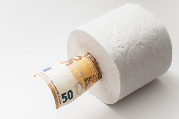 Fifty euro banknote put inside a toilet paper roll