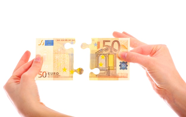 a fifty-euro note jigsaw puzzle over white background