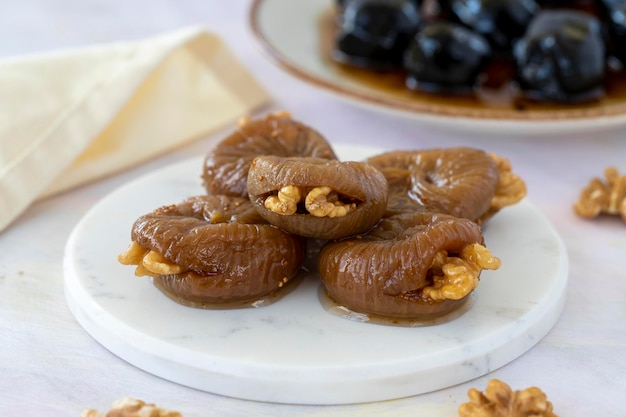 Fig dessert with walnuts on wooden background