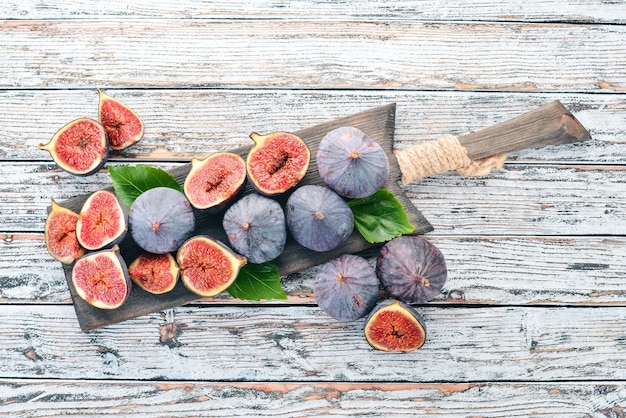 Fig Fresh fruits of figs on a white wooden table Free space for text Top view