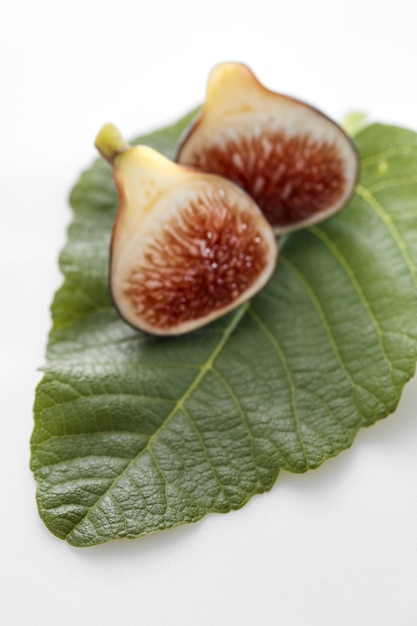 Fig fruits with leaves on white