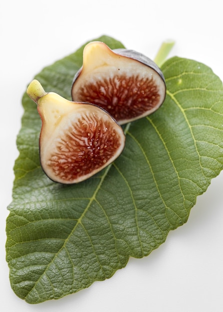 Fig fruits with leaves on white