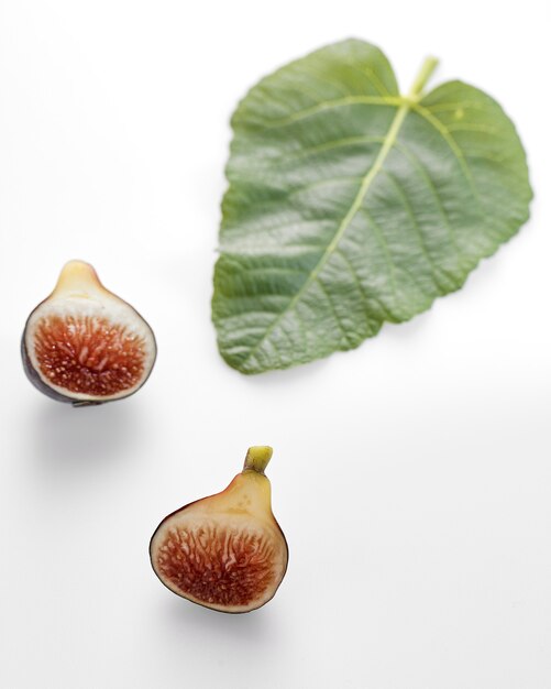 Fig fruits with leaves on white