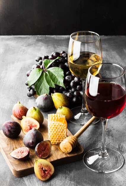 Fig, grapes, bread, honey and red and white wine