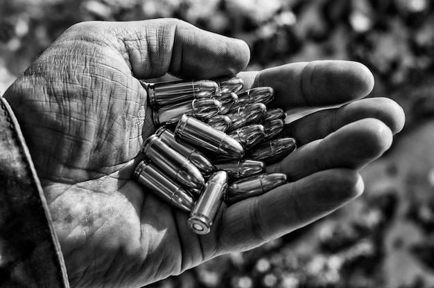 The fighter holds a handful of bullets in his palm for weapons. Mixed media