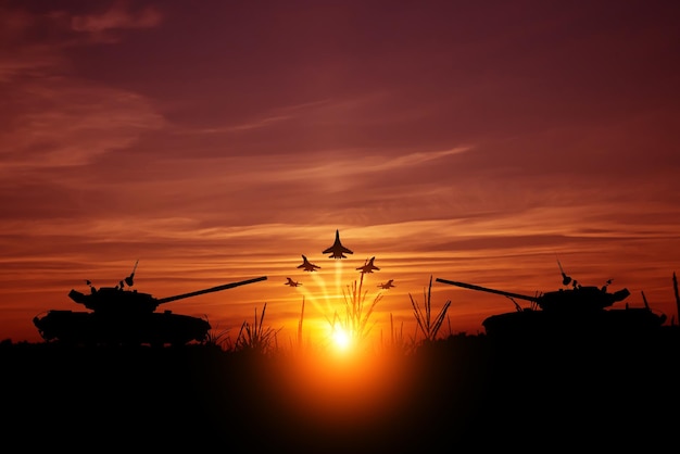 Fighters in the sky are flying on a mission against the background of the setting sun