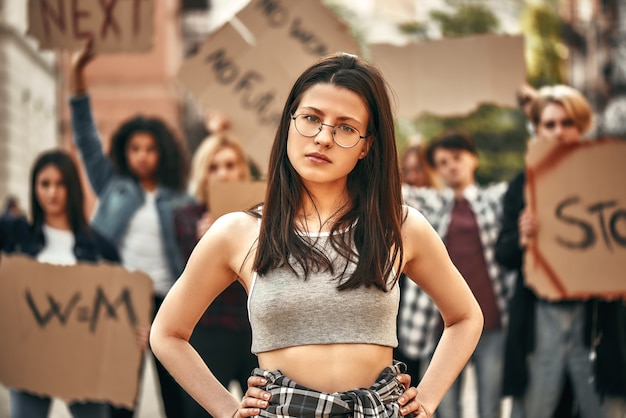 Fighting for my rights young confident woman in eyewear keeping arms on hips and looking