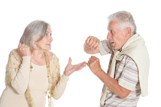 Fighting senior couple on a white background