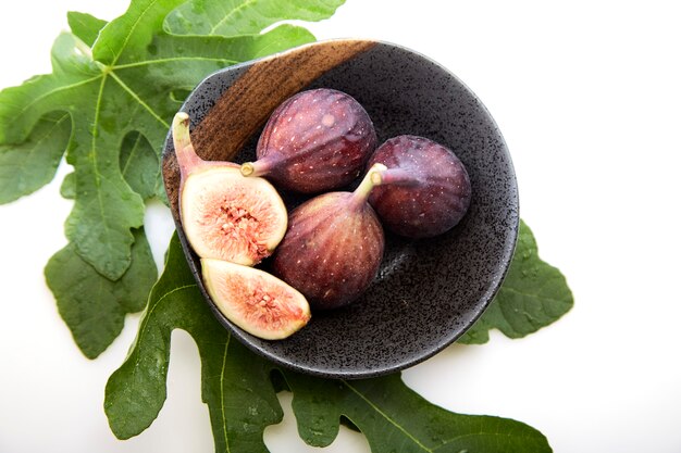 Figs in a a bowl with fig leaf