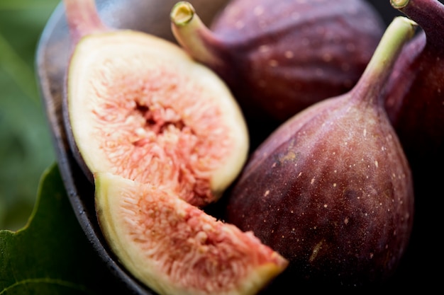 Figs in a a bowl with fig leaf