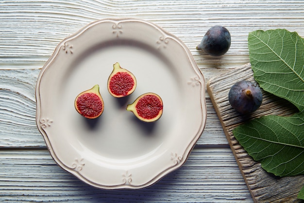 figs raw cutted fig fruits on white plate on white