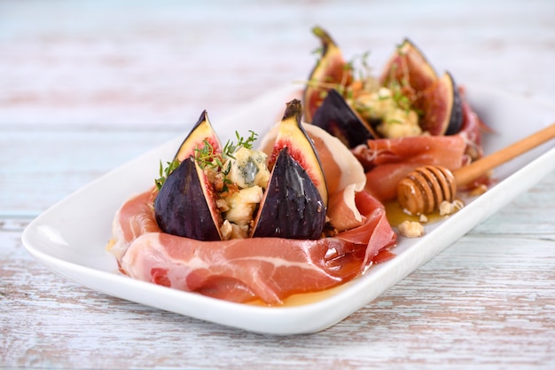 Figs stuffed with blue cheese wrapped in Parma ham and drizzled with honey