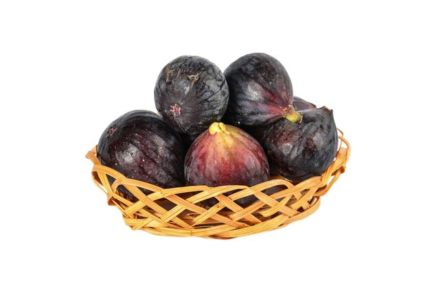 Figs in wicker basket on white background