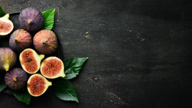 Figs on wooden background Tropical fruits Top view Free copy space