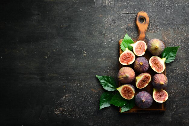 Figs on wooden background Tropical fruits Top view Free copy space