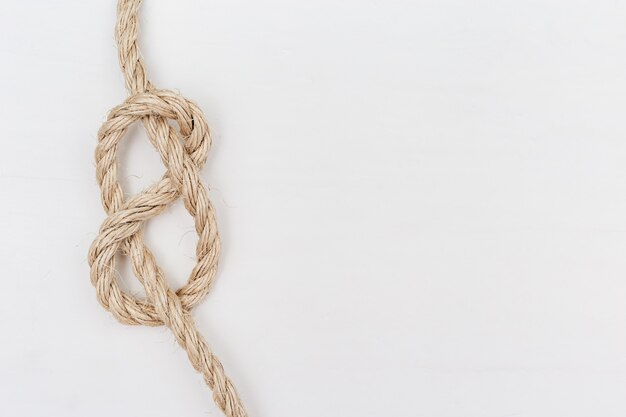 Figure-eight knot or Flemish knot on light rope, Copy space.