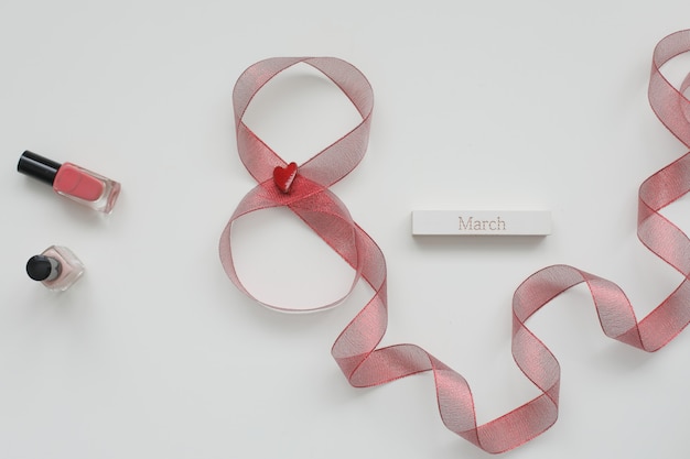 Figure eight of red ribbon and word MARCH on white background.