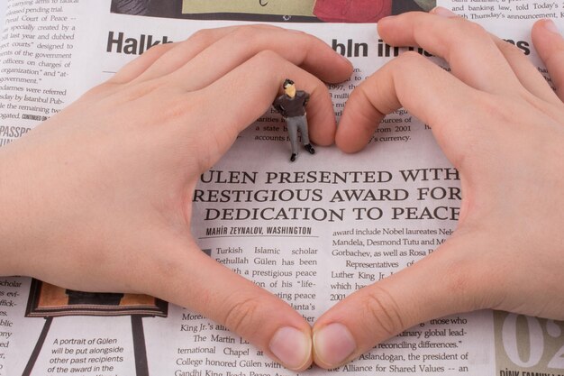 Figure in a heart on a newspaper