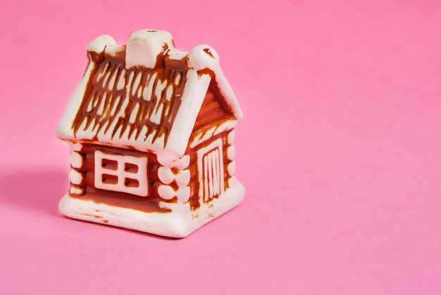 Figure of house on pink background, purchase, mortgage of house or apartment.