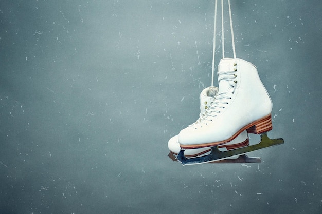 Photo figure skates are suspended against the background