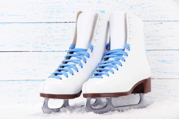 Figure skates on wooden background