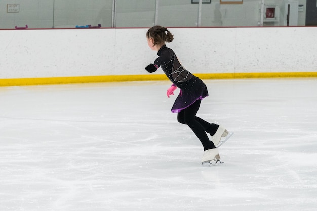 Figure skating practice at an indoor skating rink