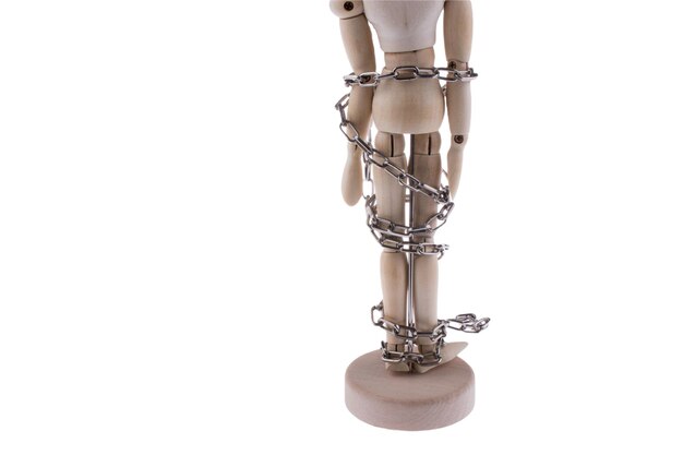 Photo figure of wooden human in chains with copy space