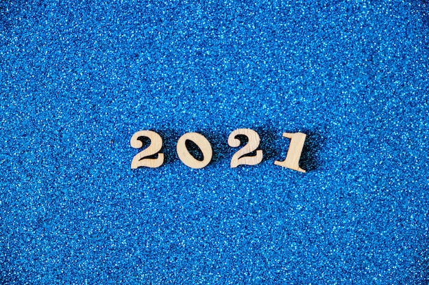 青い背景の2021年の数字。新年を迎えます。